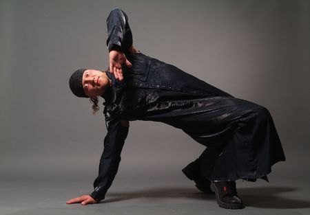 The man in a black raincoat on a grey backgroundの写真素材