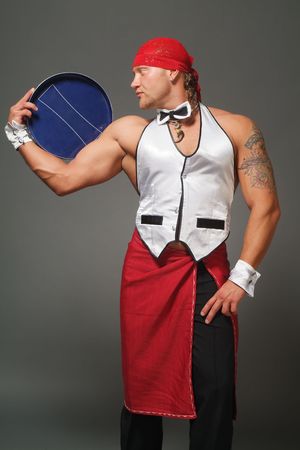 The waiter the man with a dark blue tray on a grey backgroundの写真素材