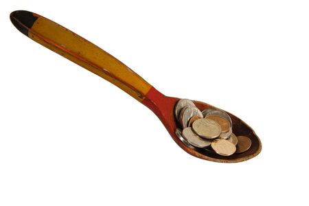 The wooden spoon filled with moneyの写真素材