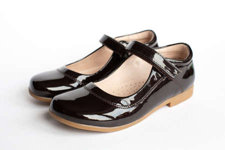childrens classic leather school shoes for a girl, school uniform isolated on a white background.の写真素材