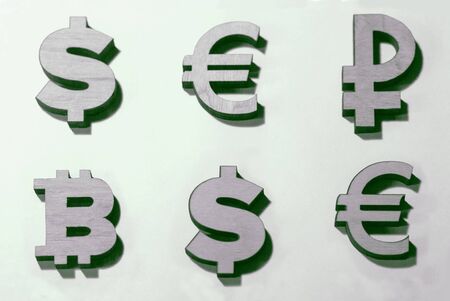 currencies of the world and bitcoins are a table as a background for comparisonの写真素材
