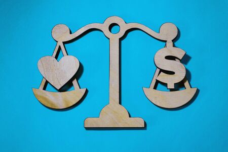 love or money on scales, the choice between material and eternal, symbolsの写真素材