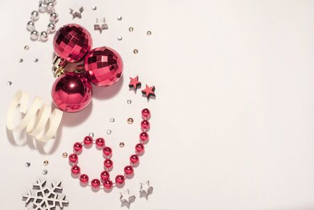 Christmas composition. Christmas balls, red decorations on white background. Flat lay, top view, copy space, place for text, design for postcardの写真素材