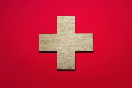 flag of Switzerland, cross and national symbol carved from wood and lies on red backgroundの写真素材