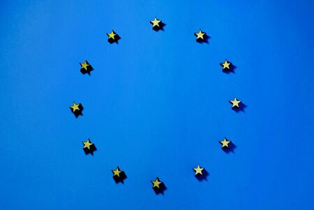 flag of the european union, stars of wood in are in circle, shadow on blue background, background, illustrationの写真素材
