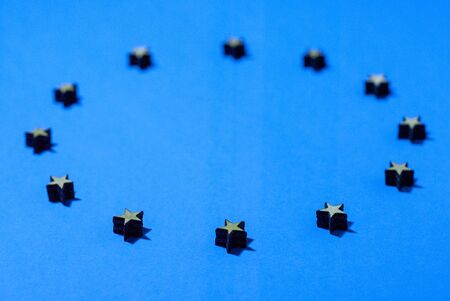 flag of the european union, stars of wood in are in a circle, shadow on blue background, background, illustration, close upの写真素材