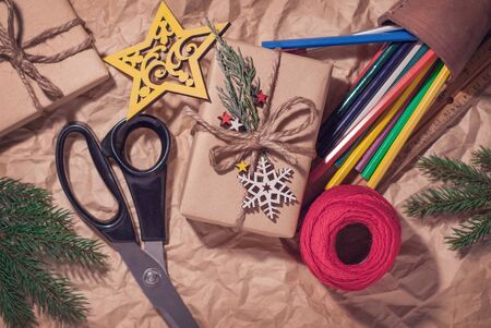 Homemade wrapped christmas presents with tools and decorations, retro backgroundの写真素材