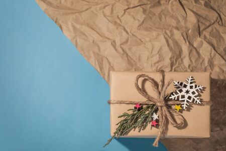 Christmas and New Year's gift on the background divided into two parts, blue and retro background, design for a postcard and a place for your textの写真素材