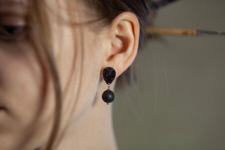 Portrait of beautiful fair young woman with jewelry, one light sourceの写真素材