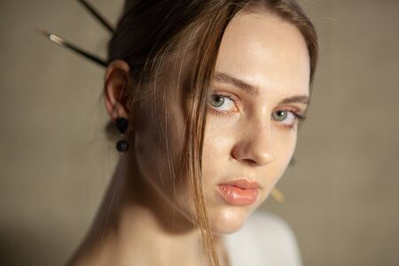 Portrait of beautiful fair young woman with jewelry, one light sourceの写真素材