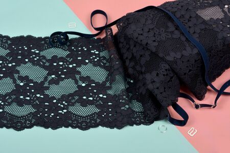Delicate color laces for panties and bras on pink and blue background with plastic fittings. Elastic...