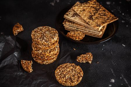 Caramel peanut brittle from sunflower seeds and sesame seeds and fitness cookies with flax seeds on...