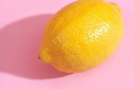 Trendy yellow lemon isometric pattern on pink background. Creative and modern minimal concept. Summer fresh flat lay food texture, copy space.の写真素材