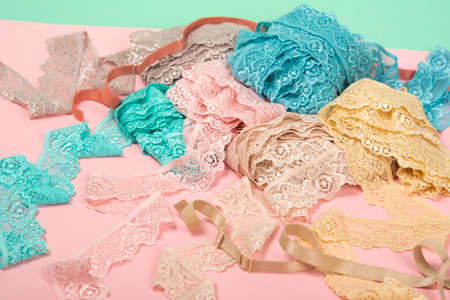 Abstract background with pile of color lace for Lingerie, panties, and bras on pink background....