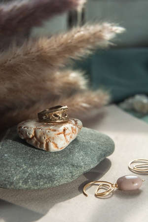 trendy vintage cast brass ring. jewelry womens ring abstract drawing closeup on a gray natural stone with shaddowsの写真素材