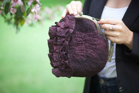 purple Elegant Felting wool fashion handmade handbag in hand. street fashion lookの写真素材