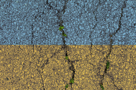 Ukraine national flags icon painted on broken weathered grungy cracked old asphalt background with...