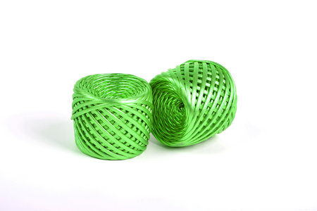 green metallized Shiny cotton kntting elastic yarn on white background. Use for crochet basket and...