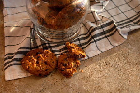 Homemade oatmeal wholemeal crunchy cookies with tasty chocolate chip in glass jar