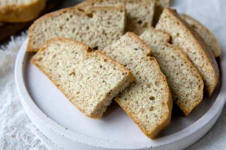 Homemade almond Low carb ketogenic bread with bran and fiber on plate, Wooden Cutting Board with...