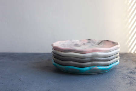Pile set of Stone curl color platter on gray conrete table, top view mockup. Plate Diy made of cement streaks, scratches and cracks. Space for text. Selective soft focus.の写真素材