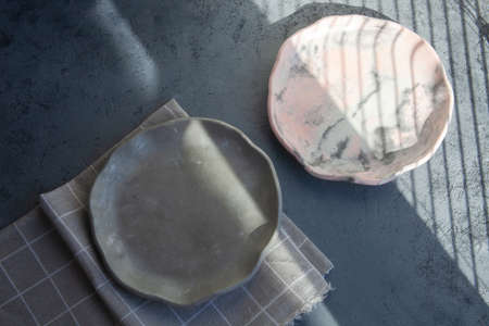 Pile set of Stone curl color platter on gray conrete table, top view mockup. Plate Diy made of...