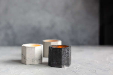 Set of color monochrome stone Candle Holder with abstract smudges, cracks gray concrete with yellow light. Use for planters, pot and decor interior. copy Space for text, selective soft focusの写真素材
