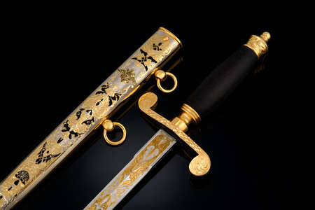 souvenir collectible silver gold dagger with scabbard on black. Luxury weapons with traditional...