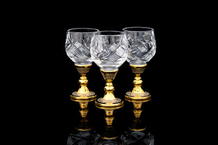 Three crystal Golden Antique Vintage Brass Shot Glass Gilded on black background. metal Wine Cup goblet with Carving Engraving pattern.の写真素材