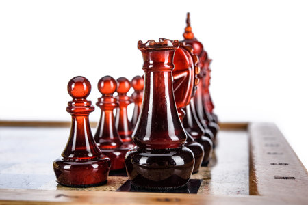 Natural amber different chess pieces figures standing on brown stone board. Close up game concept competition, Classic Gambit Tournament of confrontation.の写真素材