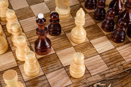 Beige Brown Wooden chess different pieces figures standing on chessboard. Close up game concept...
