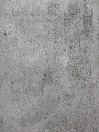 Gray Raw grunge cement wall with scratch line texture. Loft style of concrete house or building wall. Softness gray cement wall surface for background structure work. weathered concrete pattern wall.の写真素材
