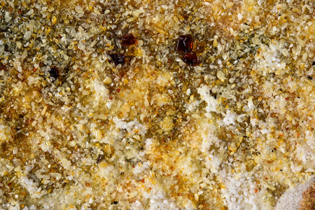 Multi colored granite Texture Mosaic of Natural gemstone Spilled amber in contour sunlight as Aesthetic Abstract background, close up, selective focus. Nature Transparent mineral pieces ancient resinの写真素材