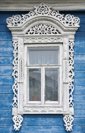 Beautiful window  with carved architravesの写真素材