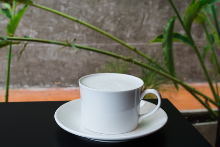 Hot milk cup on black tableの写真素材