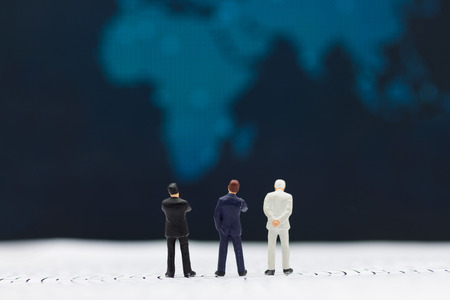Miniature people : Businessmen stand to see the profit board of the company, check the progress of...