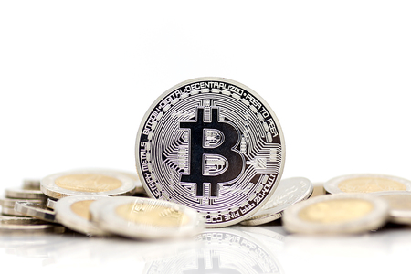 Bit-coin silver placed on the gold medal with white background, using as business concept.の写真素材