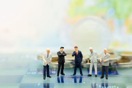 Miniature people, Group Businessmen standing on the chess game, thinking solution for the business game,  use as a business competition concept.の写真素材