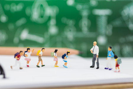 Miniature people : children studying with teacher. Image use for back to school conceptの写真素材