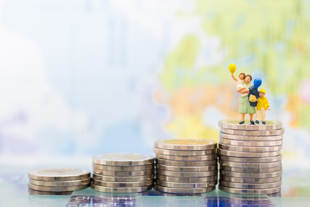 Miniature people, family figure standing on top of stack coins . Image use for background retirement planning, Life insurance concept.の写真素材