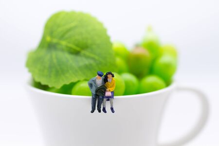 Miniature people: Couples take time for cup of coffee. Image use for food business concept.の写真素材