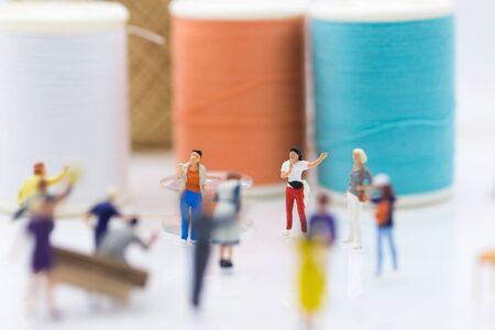 Miniature people: Group Women weaving factory protest. Image use for Claims or benefits should be earned from hard work.の写真素材