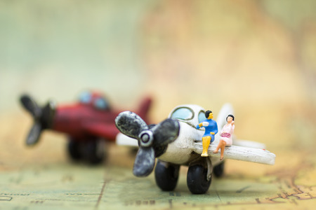 Miniature people : businesses team waiting for airplane travel around the world, business trip travel advisory agency or online world wide marketing concept.の写真素材