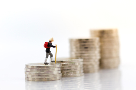 Miniature people: Old people standing on top of stack coins . Image use for background retirement planning, Life insurance concept.の写真素材