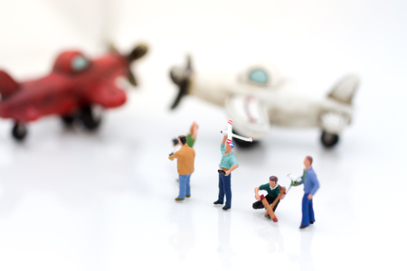 Miniature people: Group people playing and operating plane with remote control . Image use for background technology, business concept.の写真素材