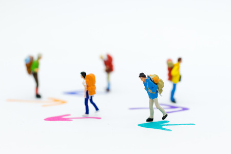 Miniature people : Backpacker group walking follow arrow. Image use for travel, business concept.の写真素材