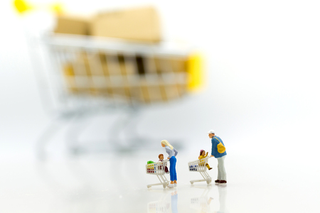 Miniature people: Shopper in shop mall with shopping cart. Image use for background business, marketing concept.の写真素材