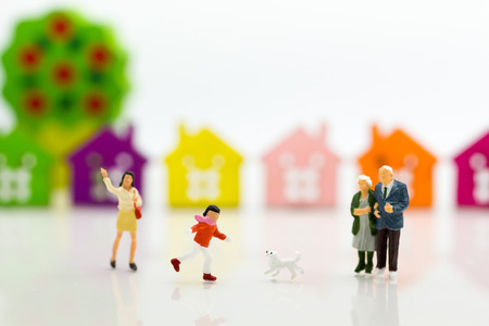 Miniature family: Boy is running with dog. Image use for Family day.の写真素材