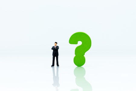 Miniature people : Businessman and question mark. Image use for find answers, solution, business concept.の写真素材
