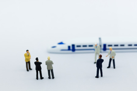 Miniature people: Businessman planning on a project for a train for traveling. Image use for transportation, business concept.の写真素材